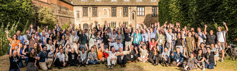 Attendees pose for group photo at Trinity College