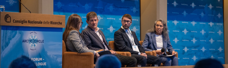 Panellists on chairs in front of audience