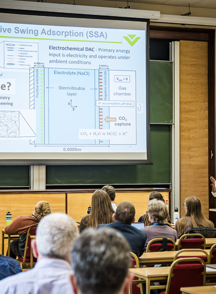 Researcher presenting slides with text "Can we scale this?"
