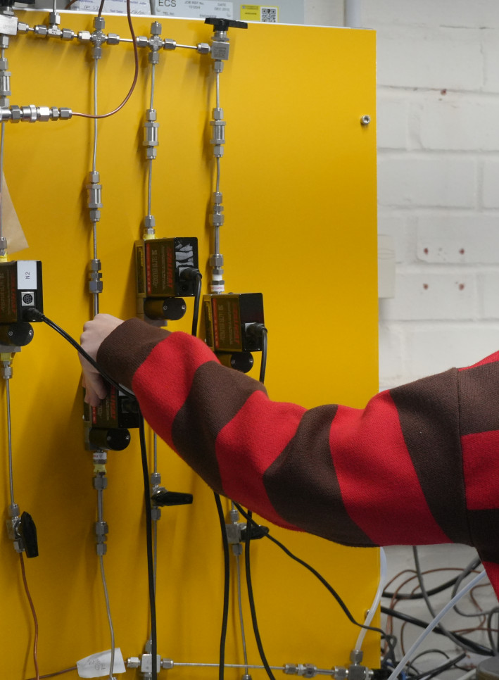 Researcher testing equipment in the lab