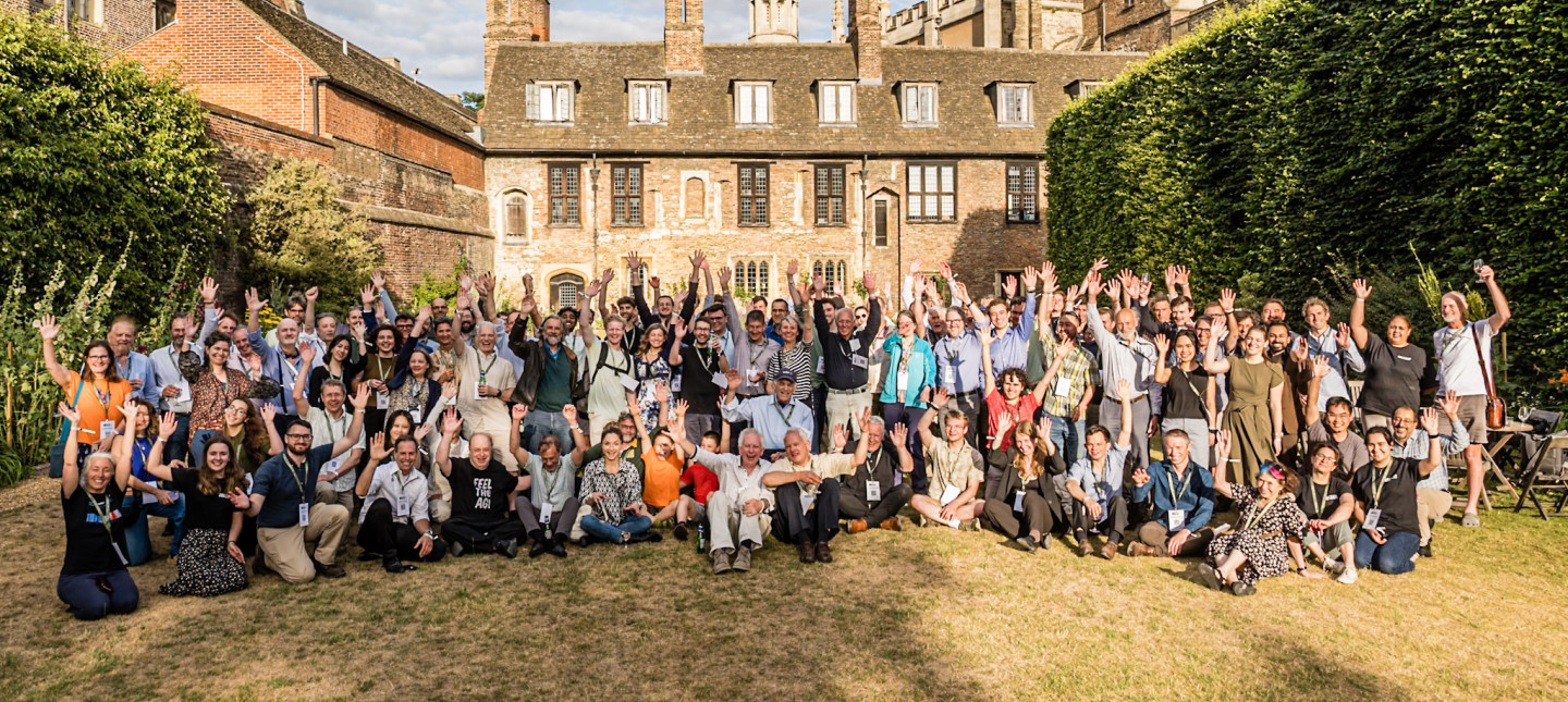 Attendees pose for group photo at Trinity College