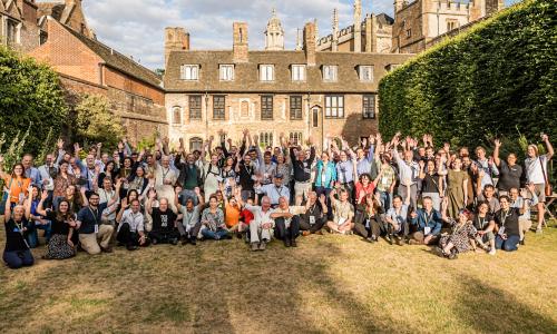 Attendees pose for group photo at Trinity College