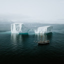 Schooner sailing by an iceberg in the Arctic. Photo by Annie Spratt on Unsplash
