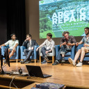 Early-career researchers in armchairs on stage at Arctic Repair