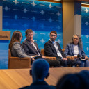 Panellists on chairs in front of audience