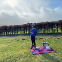 Person on a picnic blanket with goggles and remote control