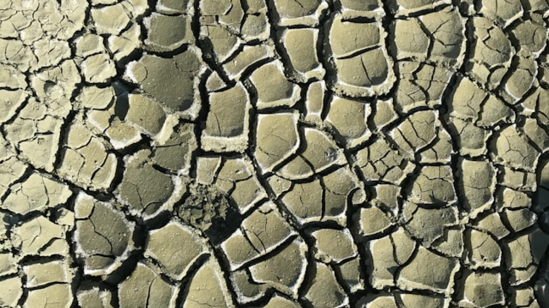 Dry, cracked earth. Free Unsplash photo by Caner Sanli 