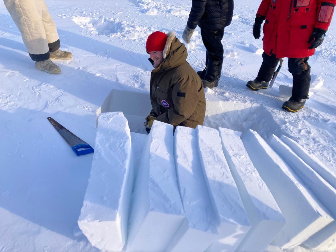 Cutting blocks of snow for shelter