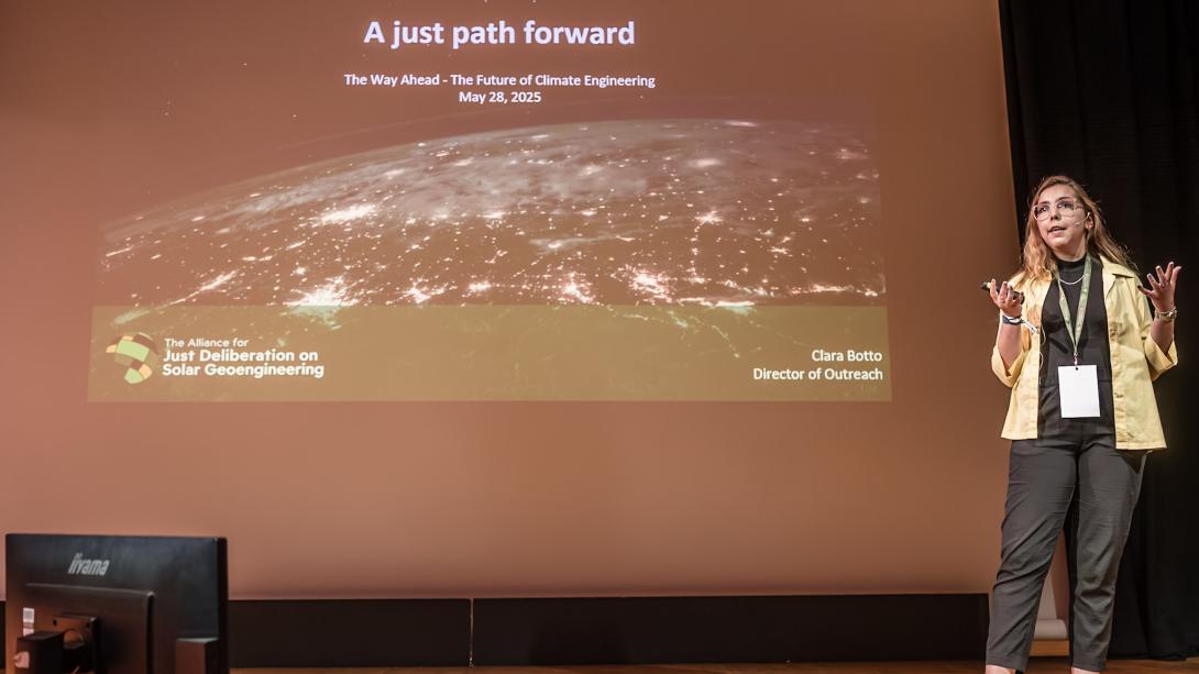 Clara speaking at Arctic Repair. Presentation reads: A just path forward