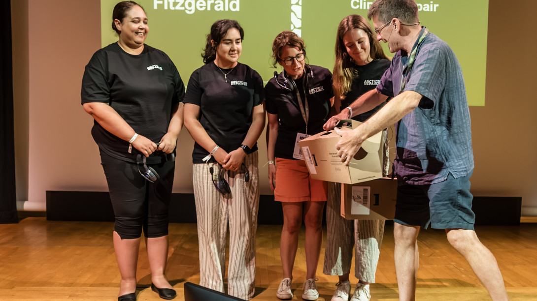The organising team receiving a gift