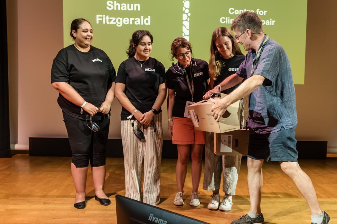 The organising team receiving a gift