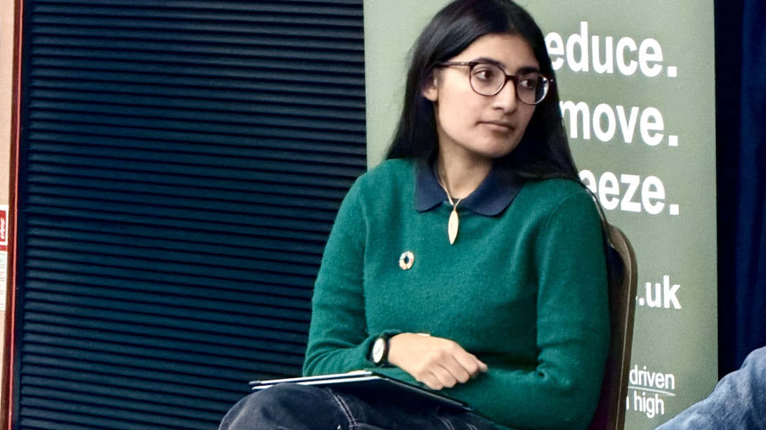 Student on a panel listening to another speaker