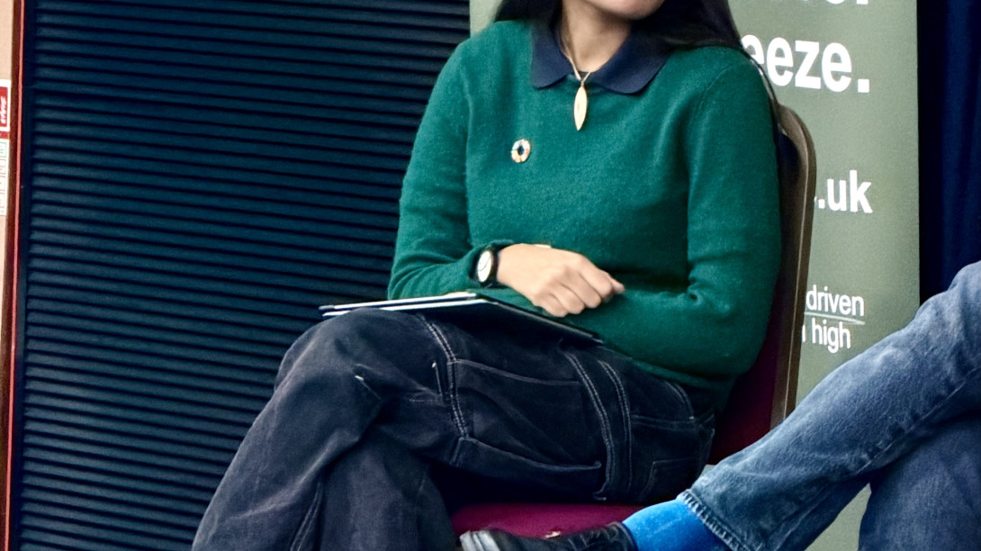 Student on a panel listening to another speaker