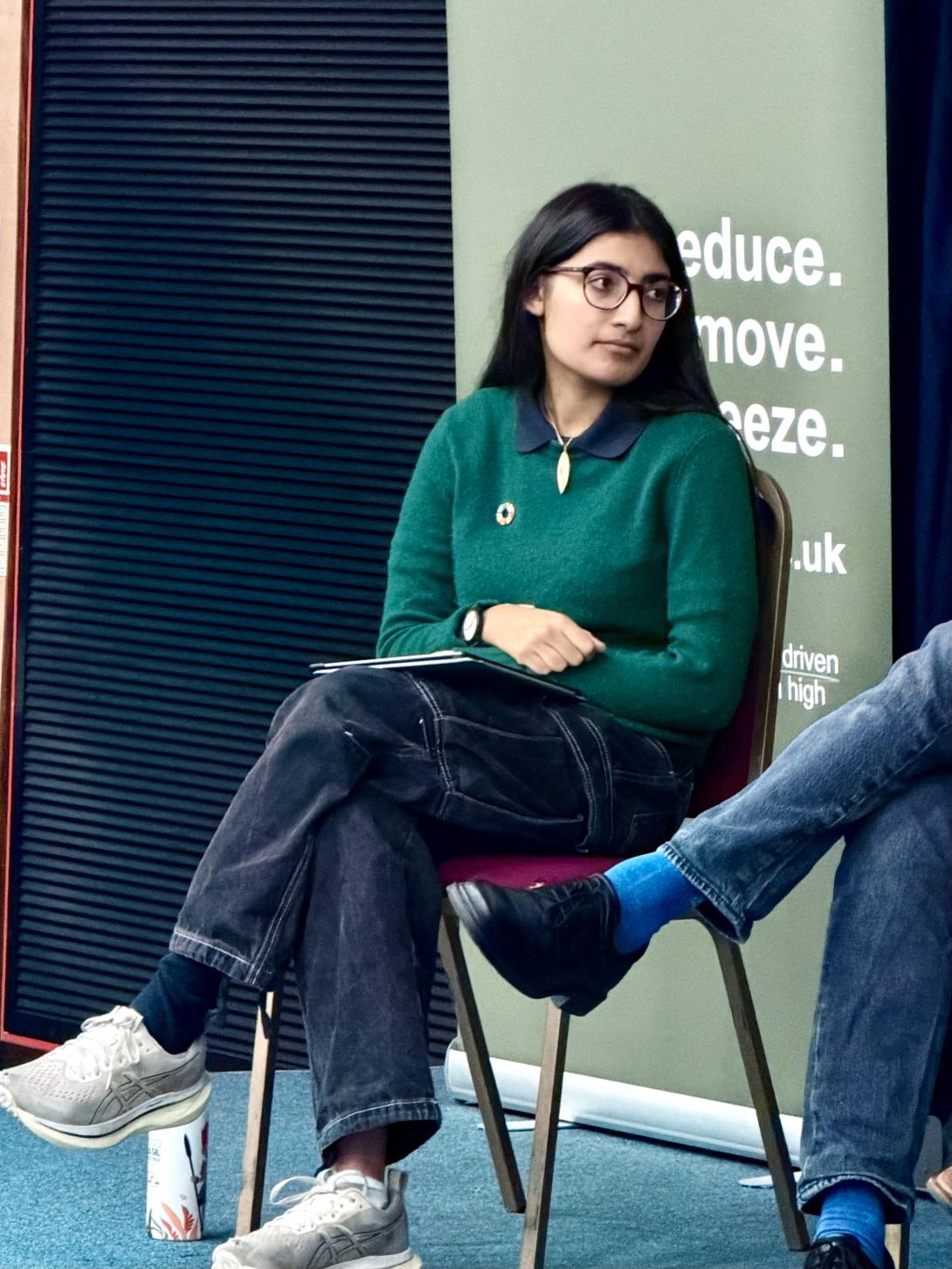 Student on a panel listening to another speaker