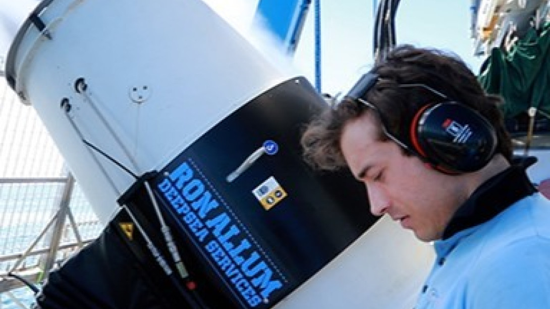 Researcher with spayer on boat