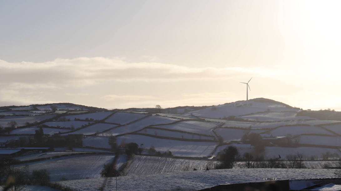 Wind turbine on snowy field