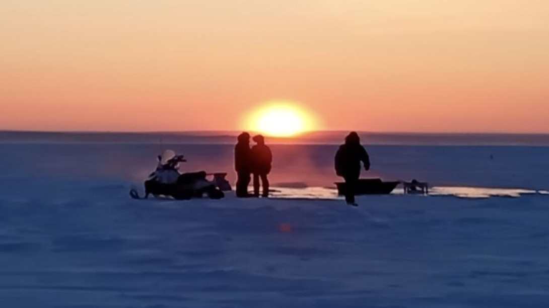 Arctic sunset over team with pumps
