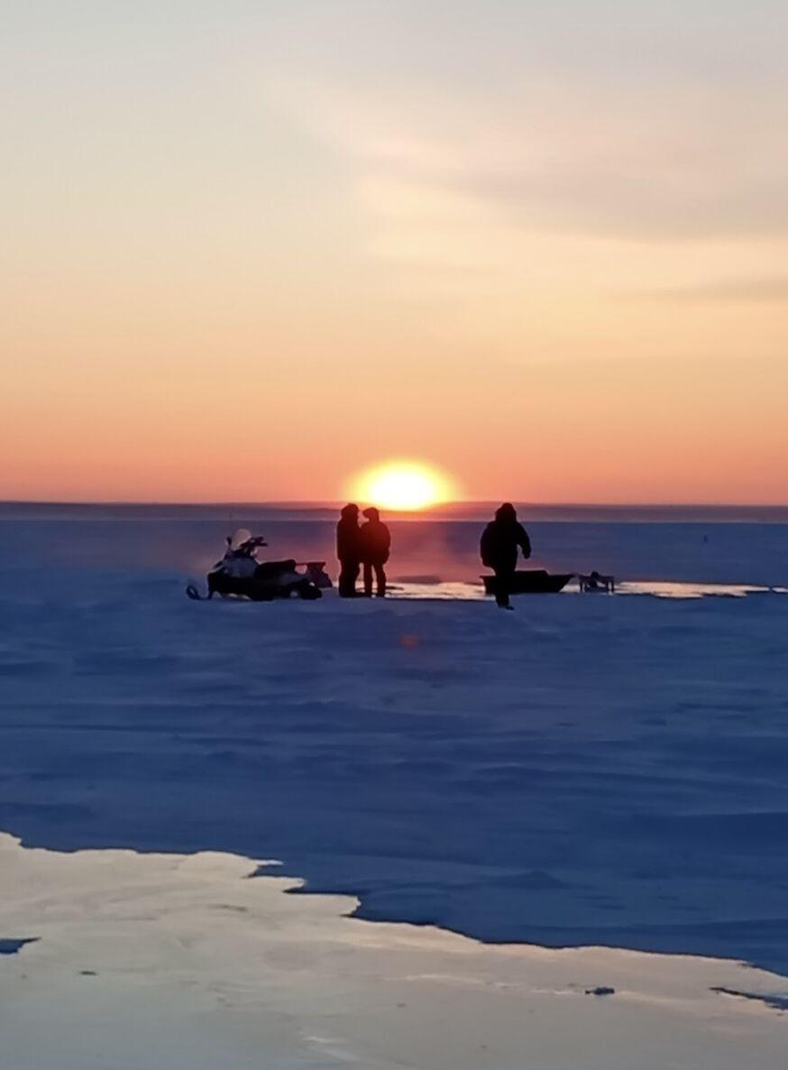 Arctic sunset over team with pumps