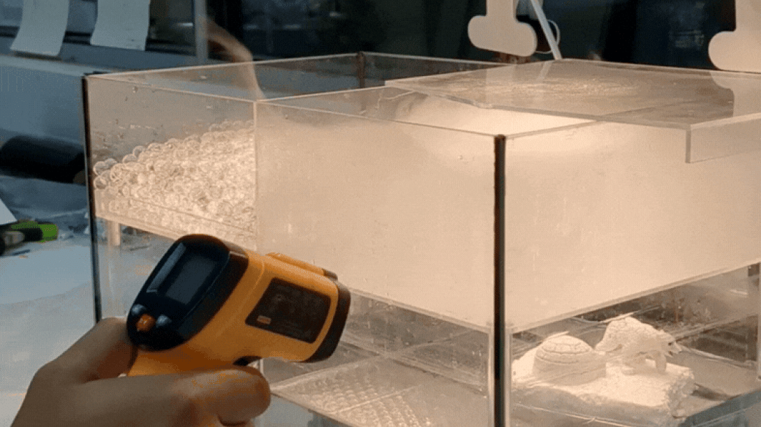 Using a thermometer to read temperature of small-scale spray plume
