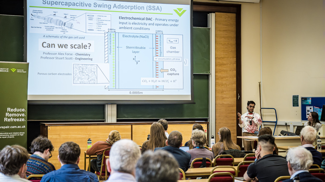 Researcher presenting slides with text "Can we scale this?"
