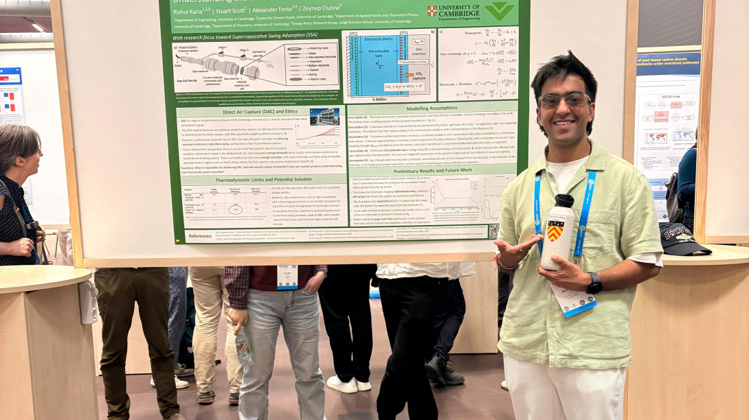 Person in front of poster at conference